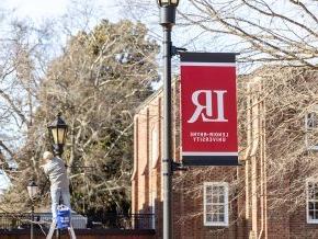 Banners on light posts along the quad by Mauney-Schaeffer during installation in late spring